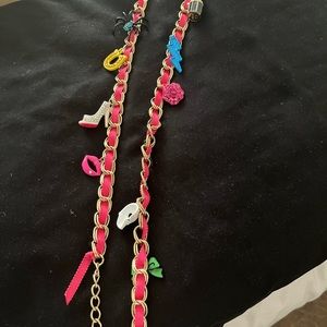 Long necklace by Betsy Johnson with multiple colorful pieces.